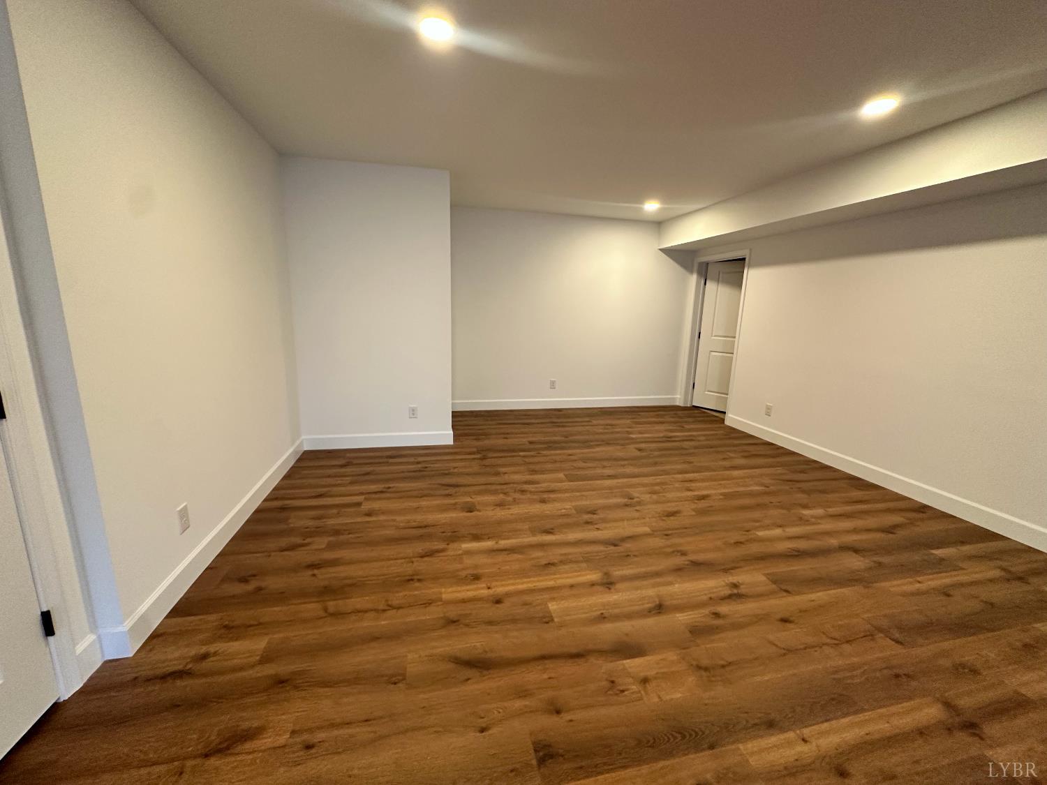 11314 Leesville Road Evington, VA 24550 - Photo 24 of 28 an empty room with wooden floor and windows