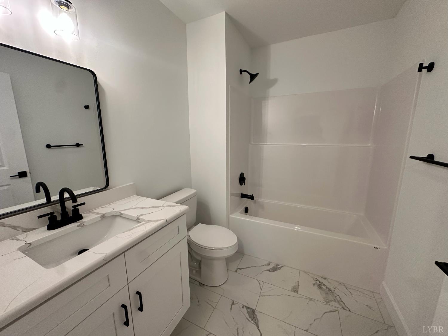 11314 Leesville Road Evington, VA 24550 - Photo 25 of 28 a bathroom with a sink toilet vanity and shower