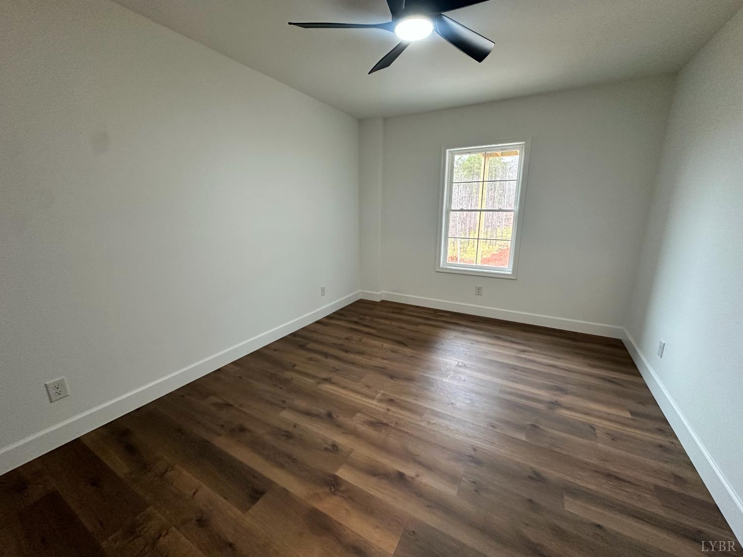 11314 Leesville Road Evington, VA 24550 - Photo 26 of 28 an empty room with wooden floor and windows