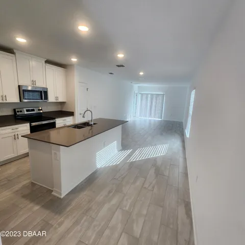 a kitchen with granite countertop a stove and a sink