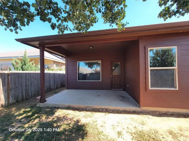 a tree in front of a white house