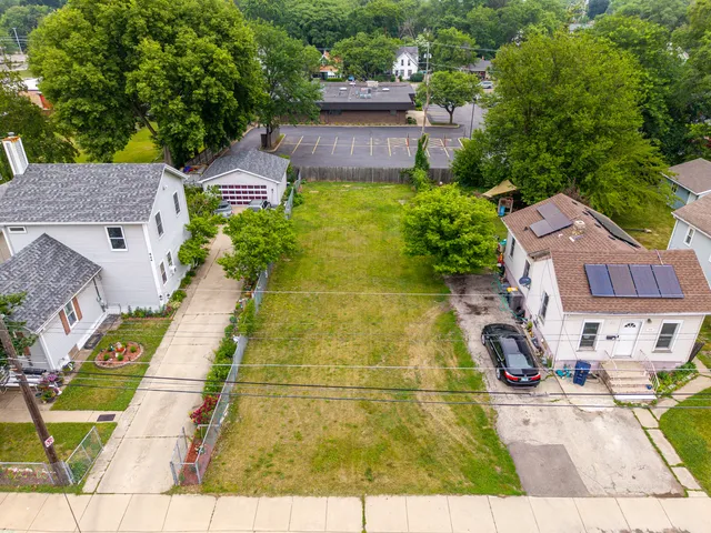 an aerial view of residential houses with yard