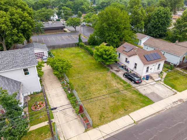 an aerial view of residential houses with yard