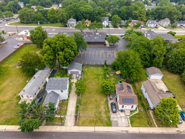 an aerial view of residential houses with outdoor space and street view
