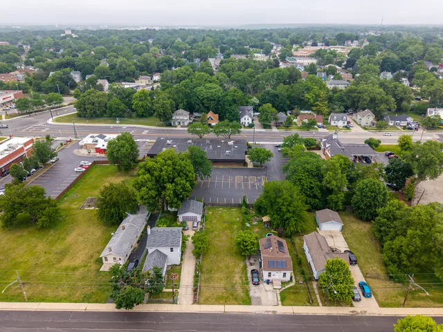 an aerial view of residential houses with outdoor space and swimming pool