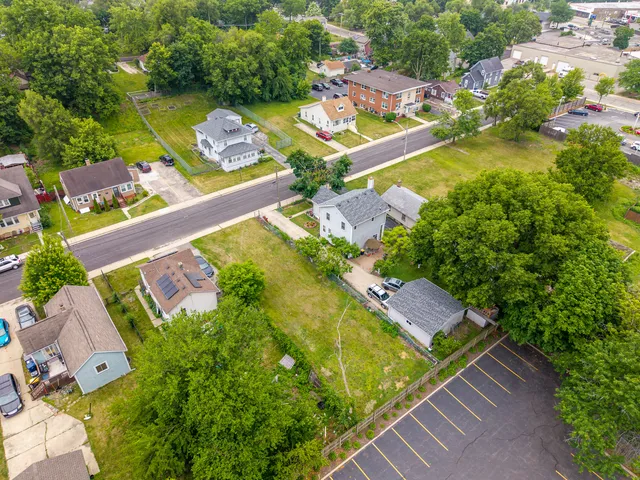 an aerial view of a house with a garden and swimming pool