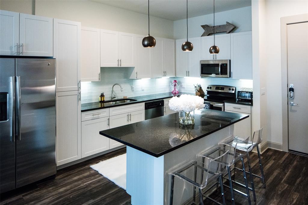 7606 Eastern Avenue, Unit 314 Dallas, TX 75209 - Photo 1 of 5 a kitchen with stainless steel appliances granite countertop a sink a stove and a refrigerator