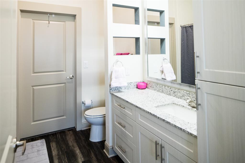 7606 Eastern Avenue, Unit 314 Dallas, TX 75209 - Photo 4 of 5 a bathroom with a granite countertop sink toilet and shower