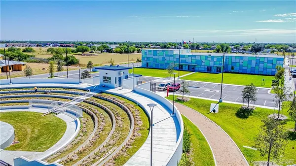 an aerial view of a swimming pool with outdoor seating