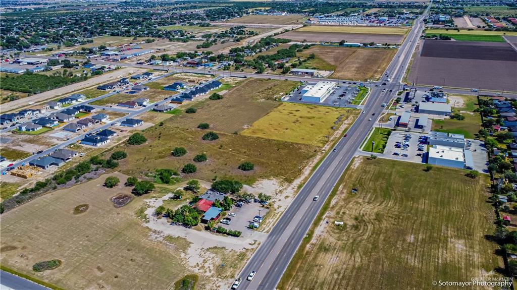 1209 East Nolana Loop Pharr, TX 78577 - Photo 3 of 18 an aerial view of a swimming pool a yard and mountain view in back