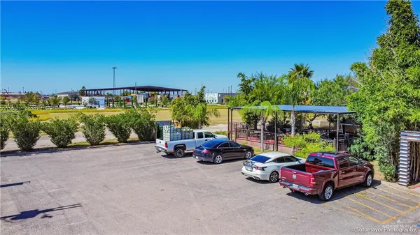a view of a swimming pool with a patio and a garden