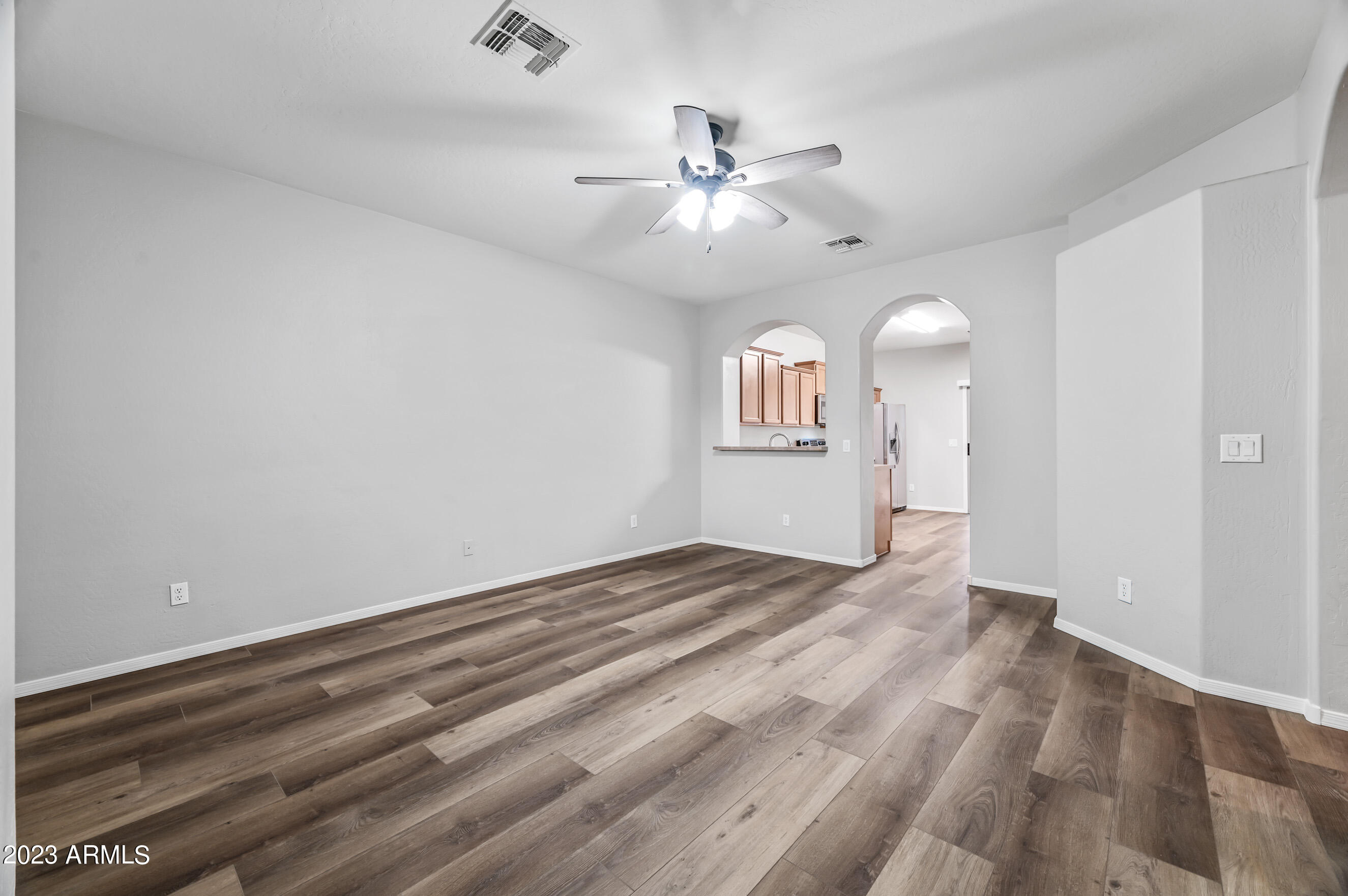 3145 South Eugene Mesa, AZ 85212 - Photo 2 of 20 a view of an empty room with a chandelier fan and a window