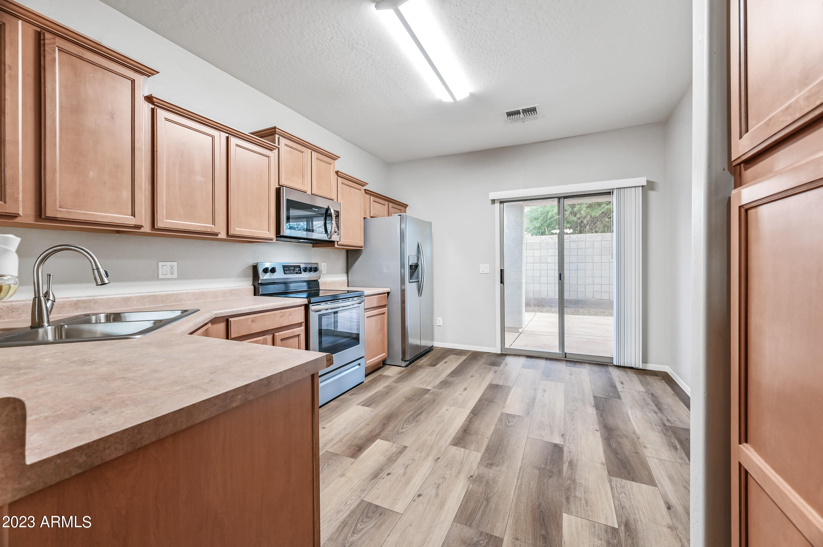 3145 South Eugene Mesa, AZ 85212 - Photo 5 of 20 a kitchen with stainless steel appliances granite countertop a refrigerator sink and cabinets