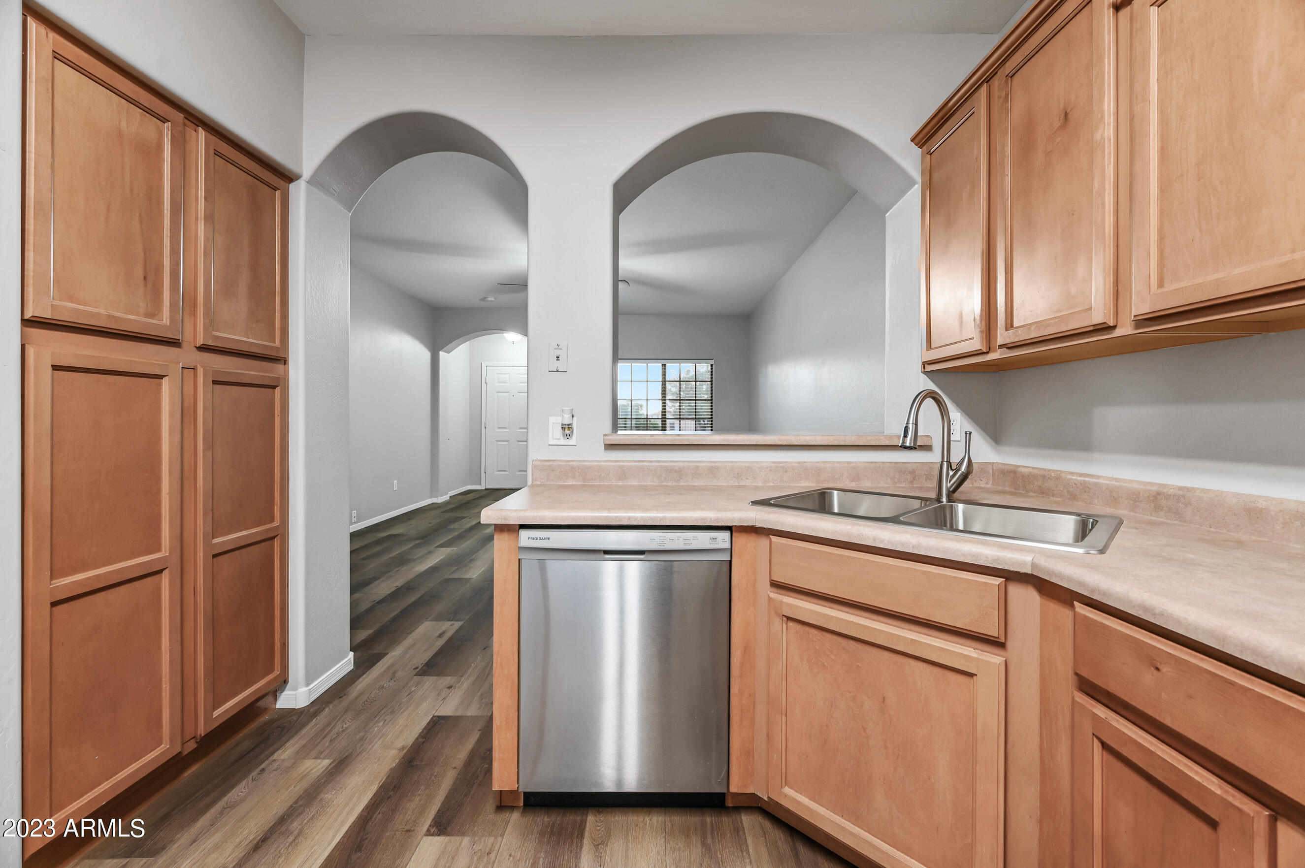 3145 South Eugene Mesa, AZ 85212 - Photo 7 of 20 a kitchen with stainless steel appliances granite countertop a sink and a refrigerator