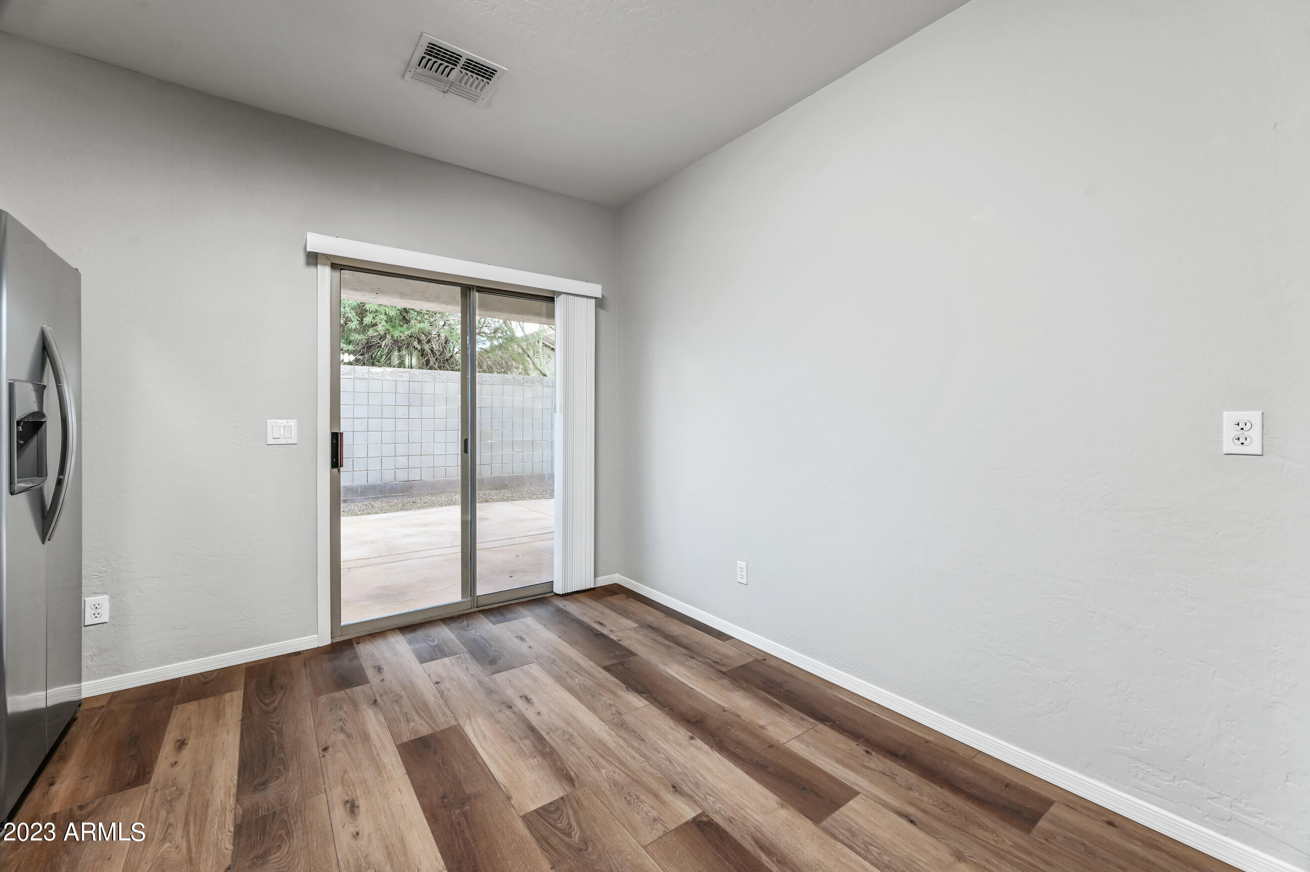 3145 South Eugene Mesa, AZ 85212 - Photo 8 of 20 an empty room with wooden floor and windows