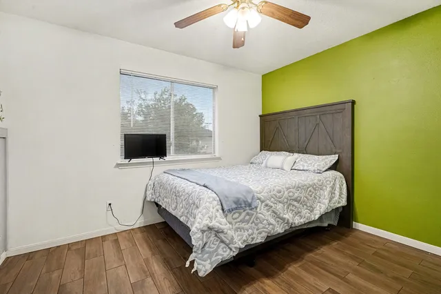 a bedroom with a bed and a flat screen tv