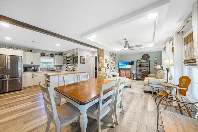a dining room with furniture and wooden floor