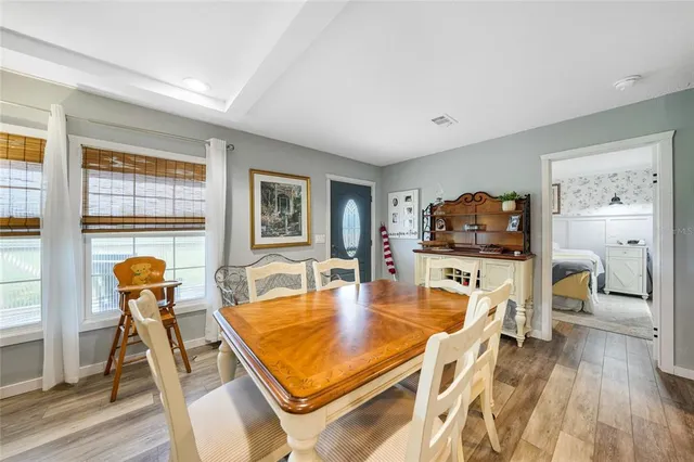 a kitchen with a refrigerator a sink and wooden floor
