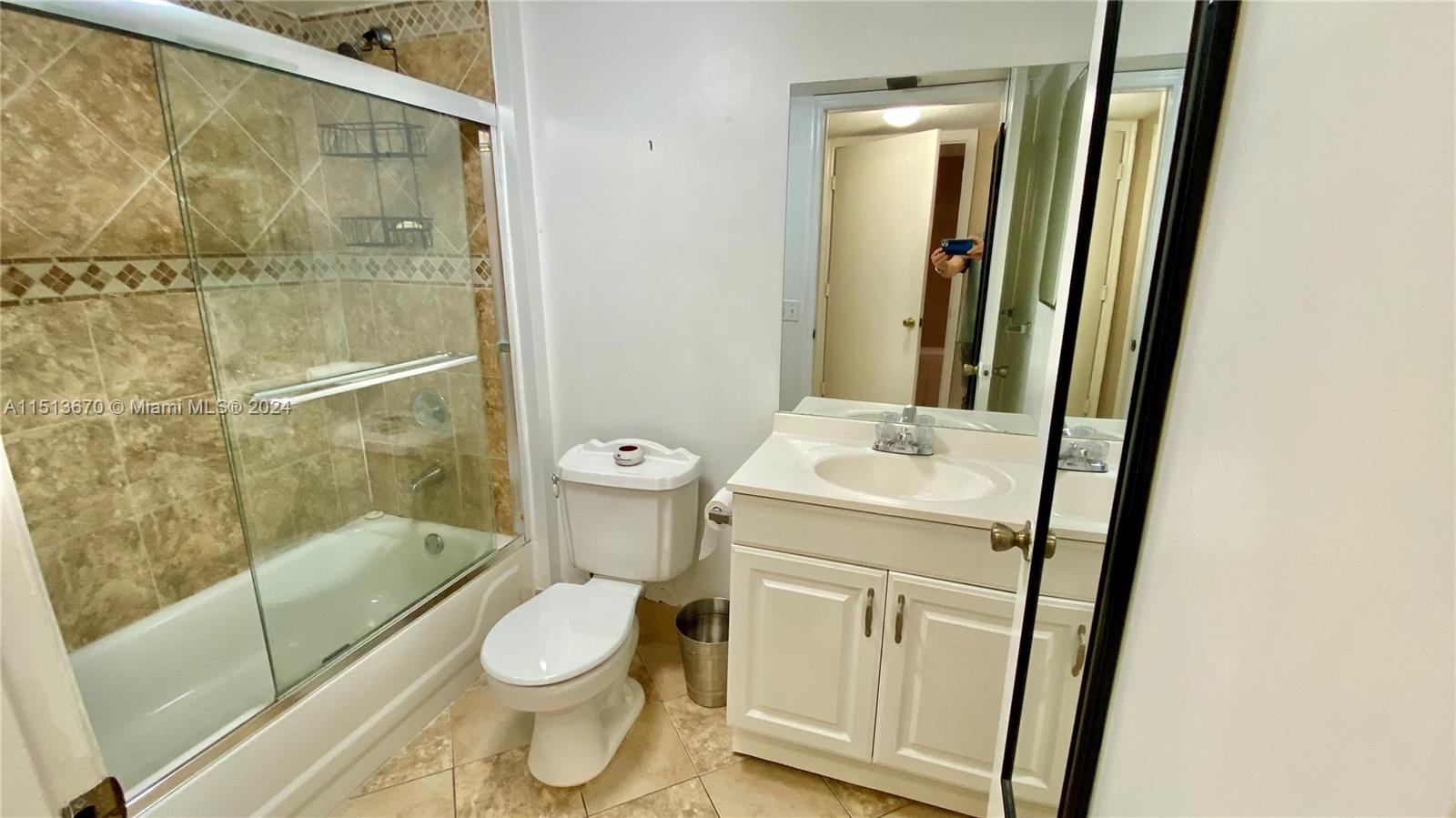 460 South Park Road, Unit 6103 Hollywood, FL 33021 - Photo 9 of 15 a bathroom with a granite countertop toilet a sink and a mirror