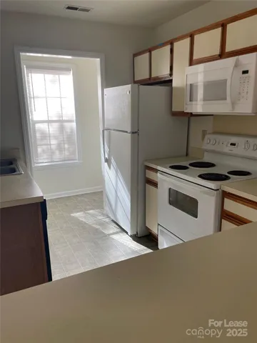 a kitchen with stainless steel appliances granite countertop a stove a refrigerator and a refrigerator