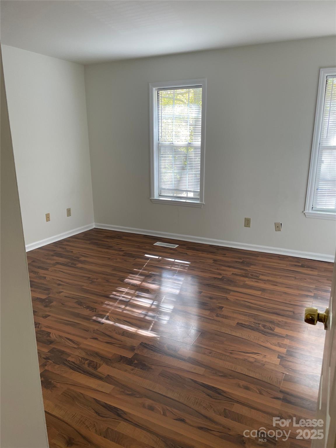 6700 Bevington Ridge Road Charlotte, NC 28277 - Photo 7 of 7 an empty room with wooden floor and windows