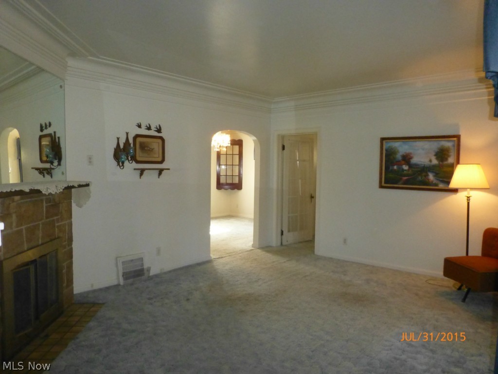 465 Butler Avenue Akron, OH 44310 - Photo 5 of 19 Living room with fireplace, hardwood floors under carpet throughout home.