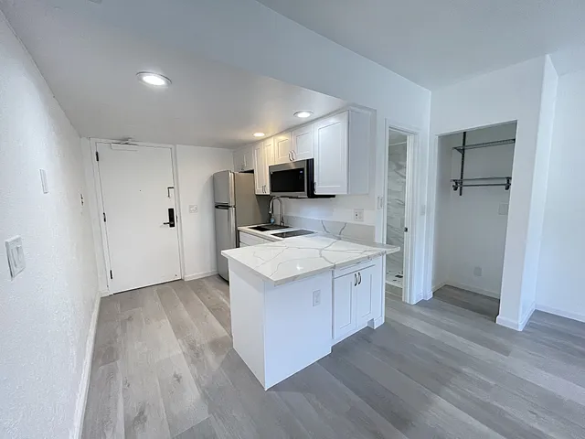a kitchen with a sink stove and refrigerator