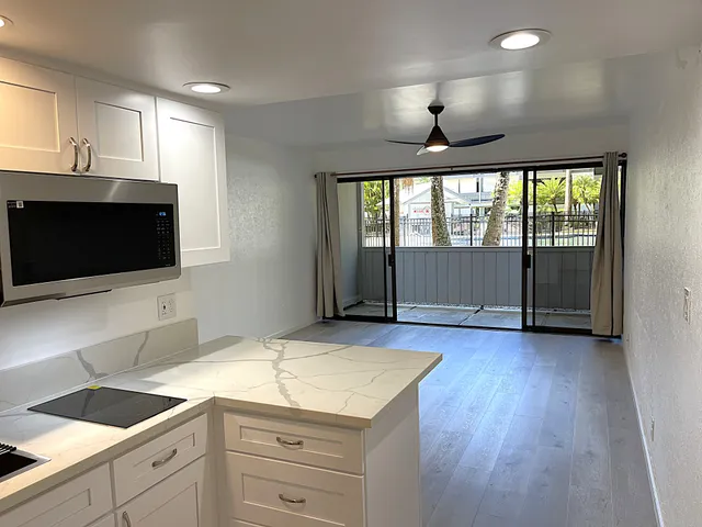 a kitchen with a sink and a large window