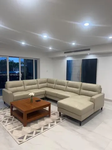 a living room with furniture and a table