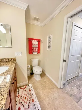 a spacious bathroom with a toilet sink and a mirror