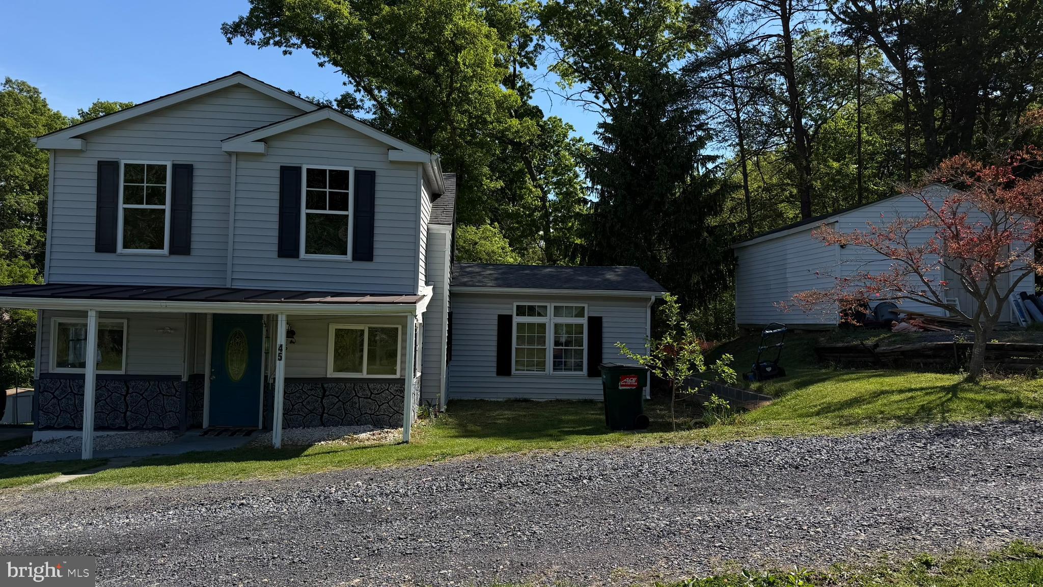 45 Figgins Road Front Royal, VA 22630 - Photo 2 of 17 a view of a brick house with many windows and a yard