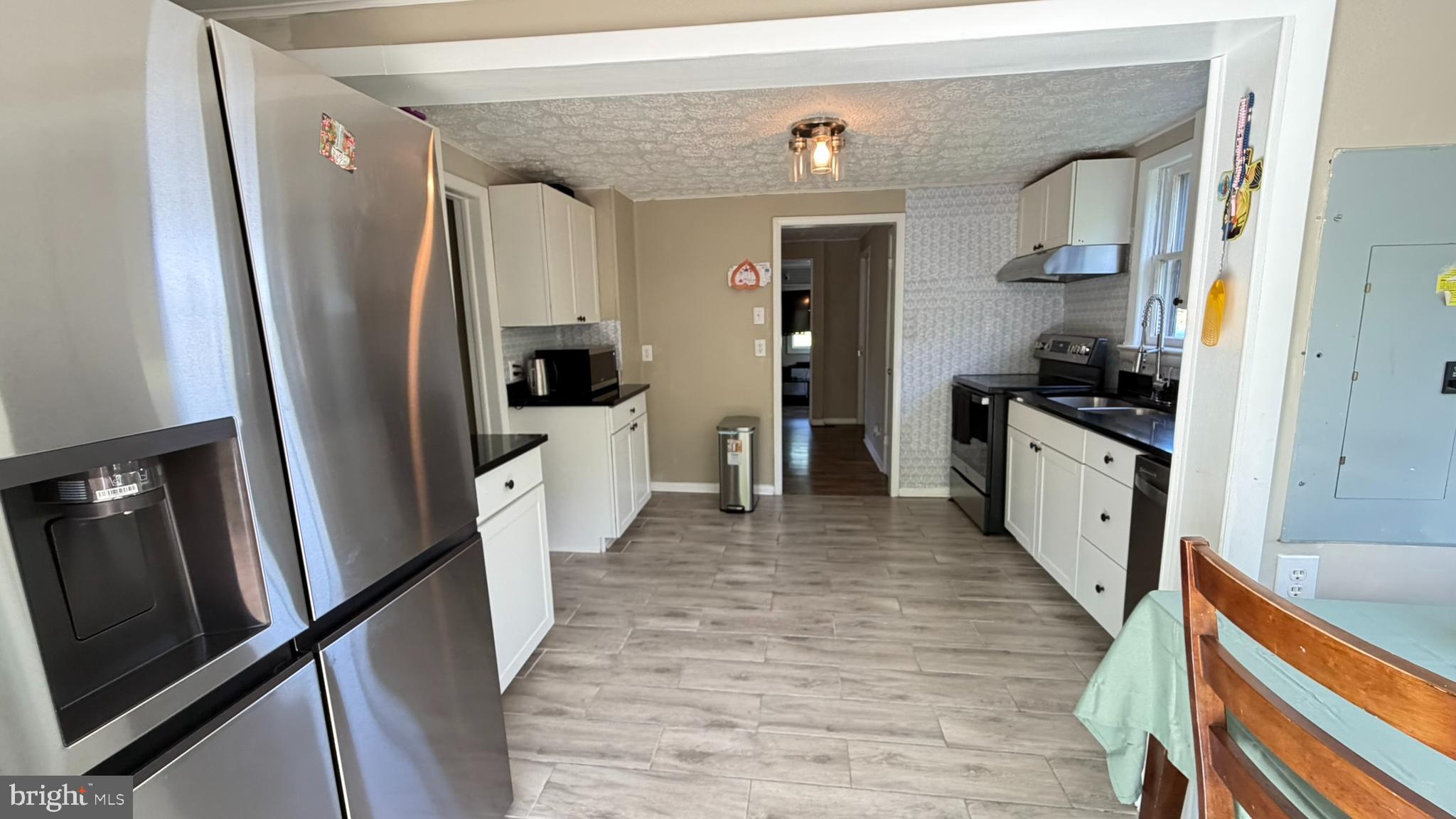 45 Figgins Road Front Royal, VA 22630 - Photo 5 of 17 a kitchen with stainless steel appliances a refrigerator a sink a stove and white cabinets