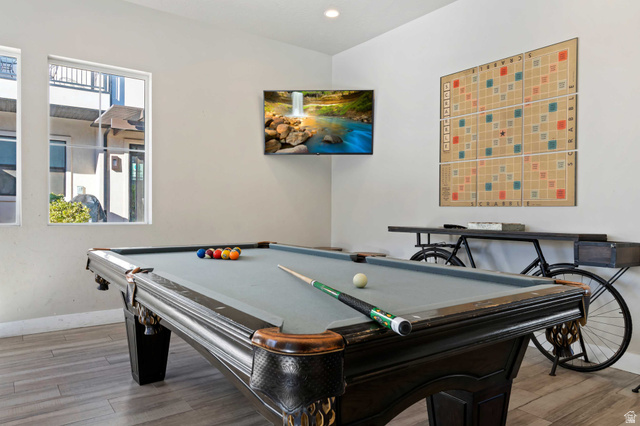 2600 Ocotillo Way, Unit 31 Santa Clara, UT 84765 - Photo 56 of 73 Recreation room featuring a classic billiards table with a light grey felt surface, wood-finish flooring, a wall-mounted flat-screen television, and multiple large windows for natural illumination