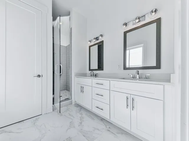 a bathroom with double sink and a mirror