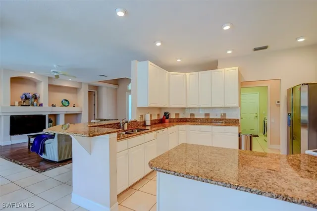 a kitchen with stainless steel appliances granite countertop sink stove and cabinets