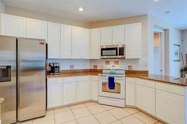 a kitchen with cabinets stainless steel appliances and a sink