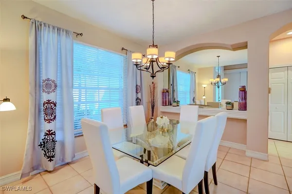 a view of a dining room with furniture and chandelier