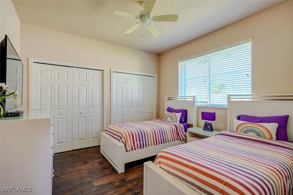 a bedroom with two beds and a chandelier