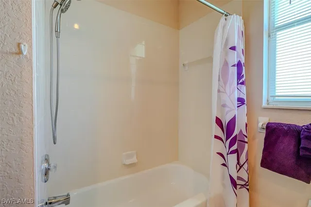a bathroom with a bathtub and shower curtain