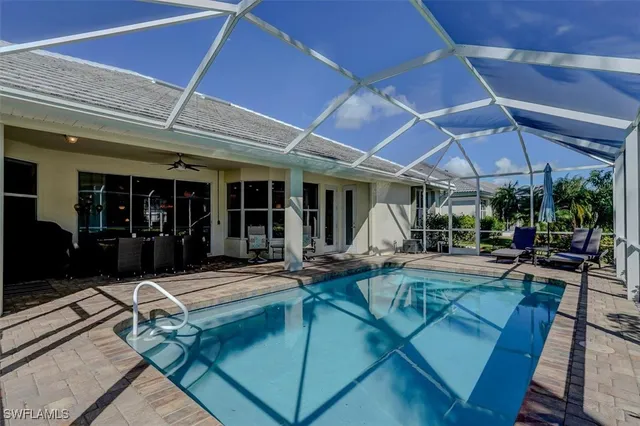 a view of a patio with table and chairs under an umbrella