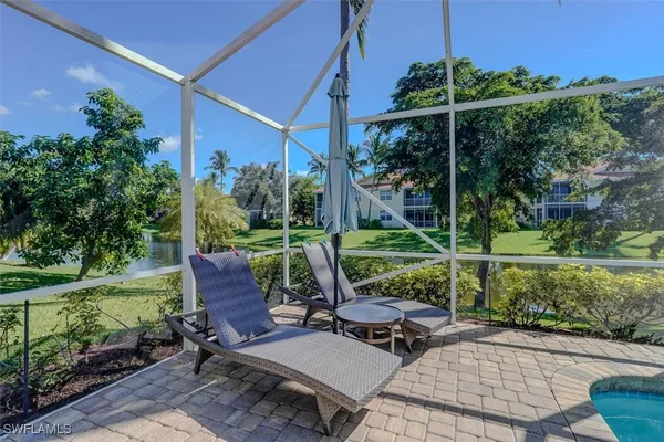a view of a patio with table and chairs potted plants and palm tree
