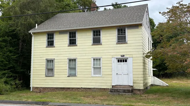 a front view of a house with a yard