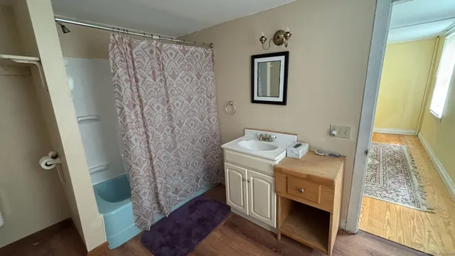 a bathroom with a granite countertop sink toilet and shower