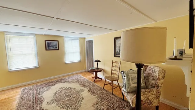 a bedroom with furniture and a window