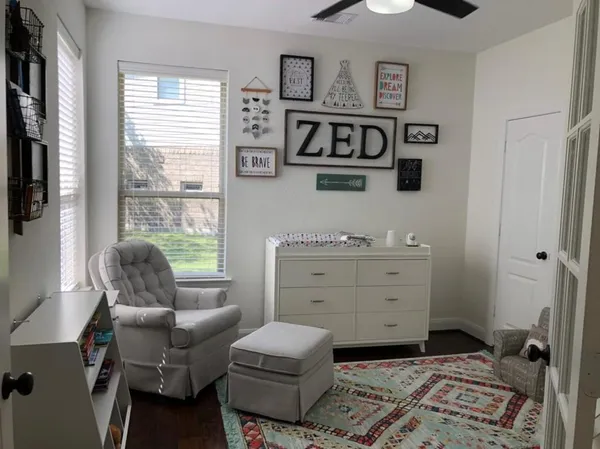 a room with a baby crib furniture and a window