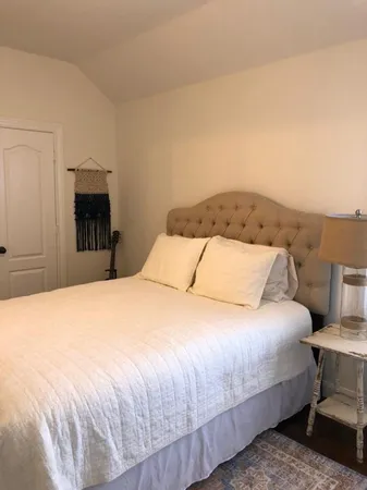 a large bed sitting in a bedroom and dresser