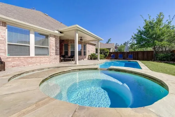 a view of a house with swimming pool and sitting area