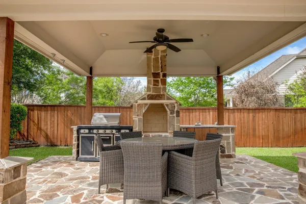 a view of a patio with table and chairs