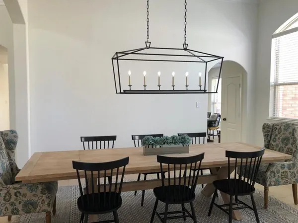 a view of a dining room with furniture and window