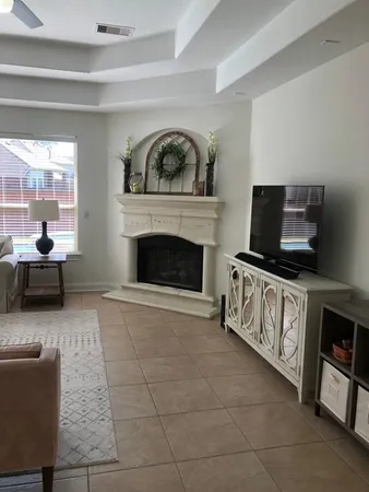 a living room with furniture and a fireplace